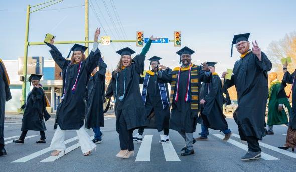 A group of students cross the street.