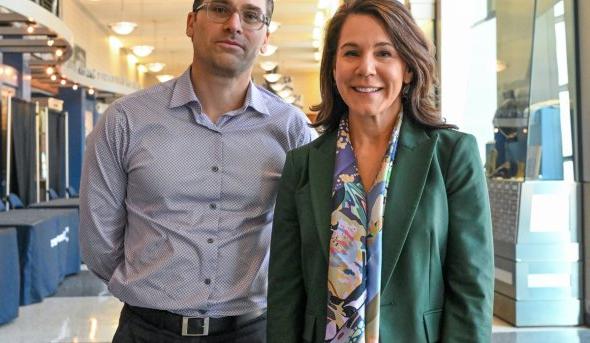 A man and a woman pose for a photo. 