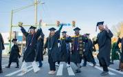 A group of students cross the street.