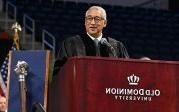 Photo of a man speaking at a podium.