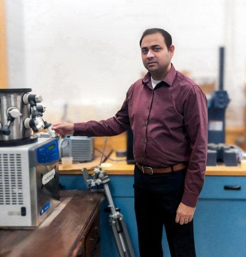 Dr. Dipankar Ghosh stands inside laboratory